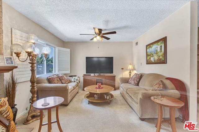 carpeted living room featuring a textured ceiling and ceiling fan