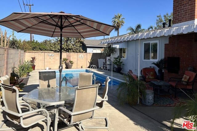 view of patio featuring a fenced in pool