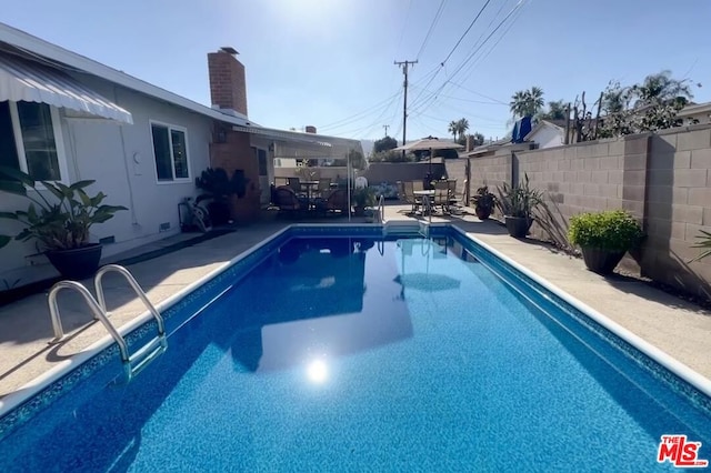 view of swimming pool featuring a patio area