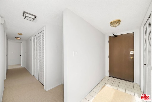 hallway featuring light tile patterned floors