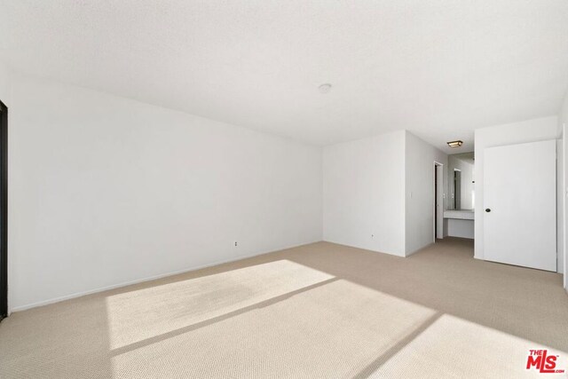 unfurnished room with light colored carpet