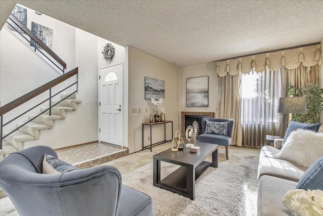 carpeted living room with a brick fireplace and a textured ceiling