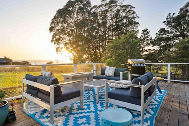 deck at dusk featuring an outdoor living space and a grill