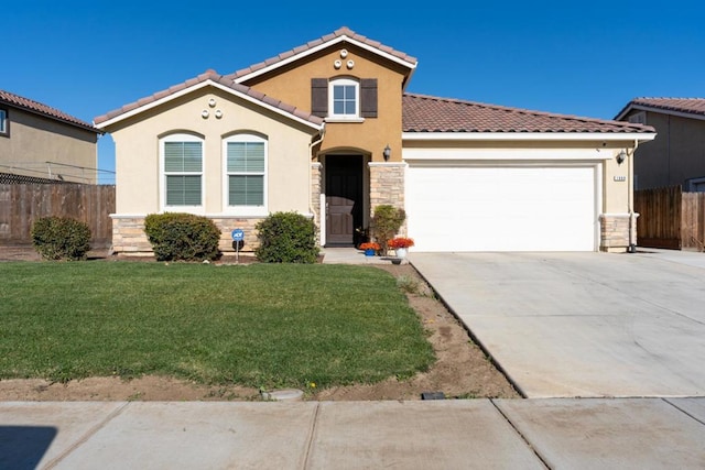 mediterranean / spanish home with a garage and a front yard