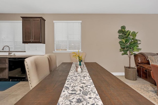 tiled dining room featuring sink