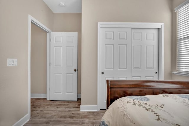 bedroom with a closet and light hardwood / wood-style flooring