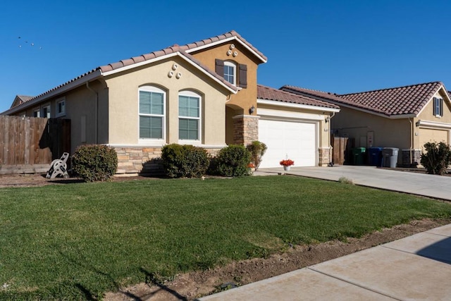 mediterranean / spanish-style home with a front yard and a garage