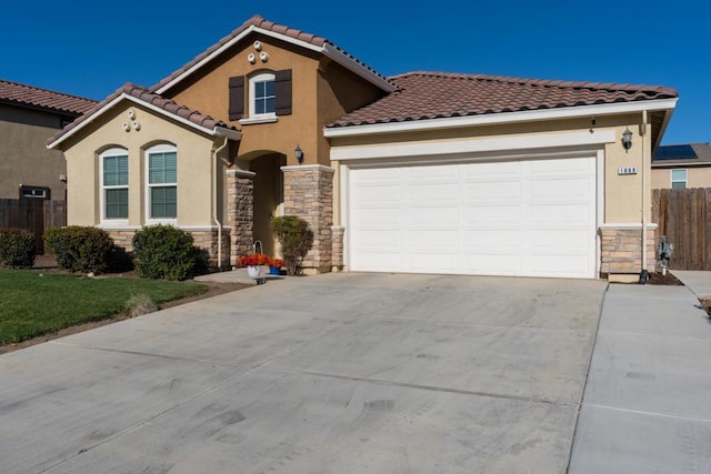 mediterranean / spanish home with a garage