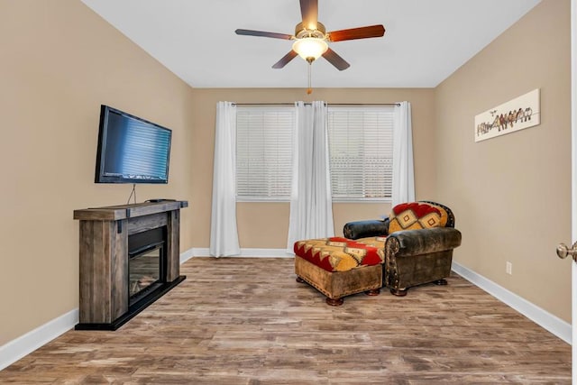 living area featuring ceiling fan and hardwood / wood-style floors