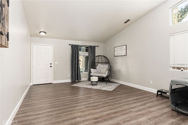 sitting room featuring vaulted ceiling and hardwood / wood-style flooring