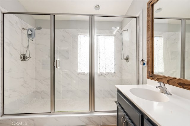 bathroom with vanity and a shower with door