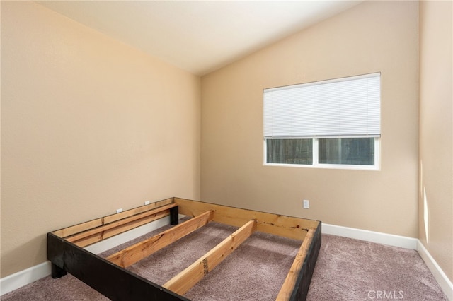 carpeted bedroom featuring lofted ceiling