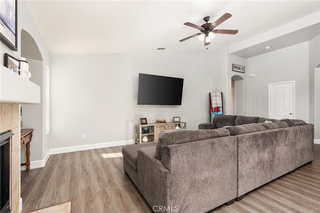 living room with ceiling fan and light hardwood / wood-style floors