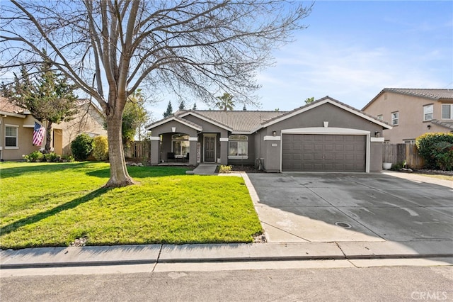 view of front of property featuring a front yard and a garage