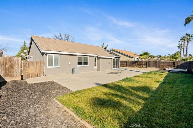 rear view of house with a patio area and a lawn