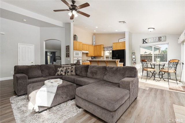 living room featuring ceiling fan and light wood-type flooring