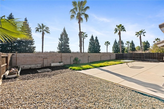 view of yard featuring basketball hoop