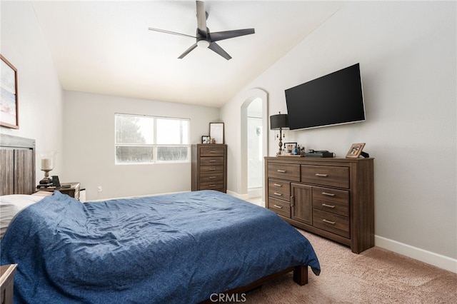 bedroom with ceiling fan, light colored carpet, and vaulted ceiling