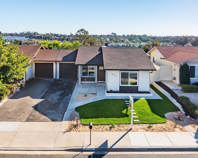 ranch-style home featuring a front yard and a garage