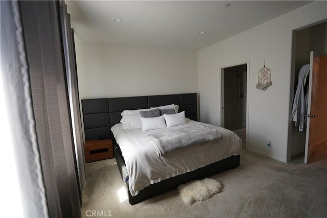 carpeted bedroom featuring a walk in closet