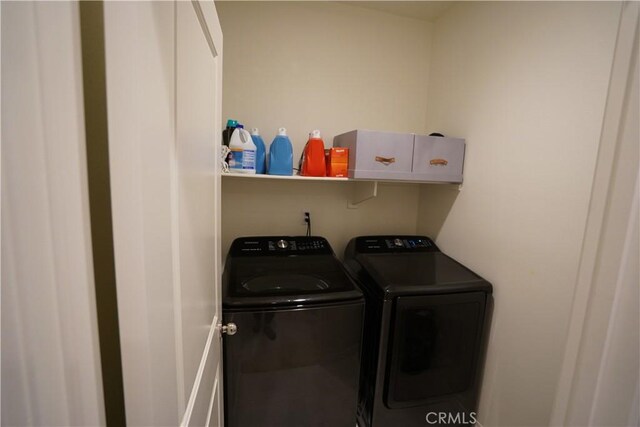 laundry area featuring washing machine and clothes dryer