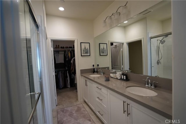 bathroom featuring tile patterned floors, walk in shower, and vanity