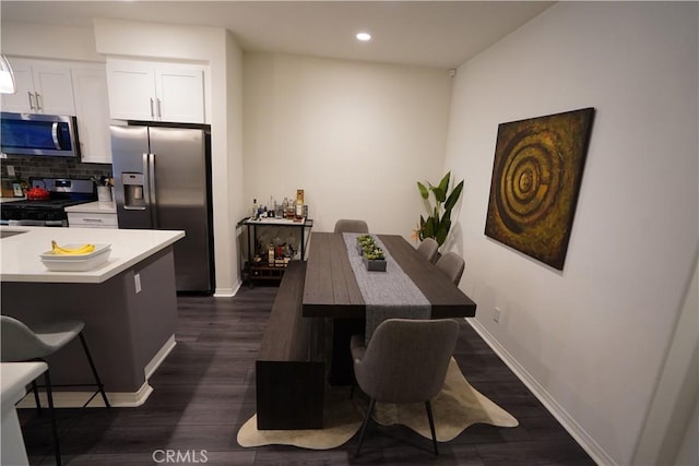 dining room with dark wood-type flooring