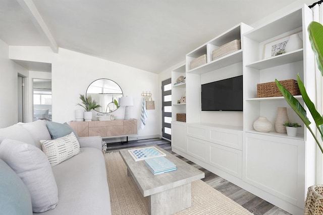 living room featuring vaulted ceiling with beams and wood-type flooring