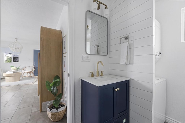 bathroom with tile patterned floors, vanity, and a notable chandelier