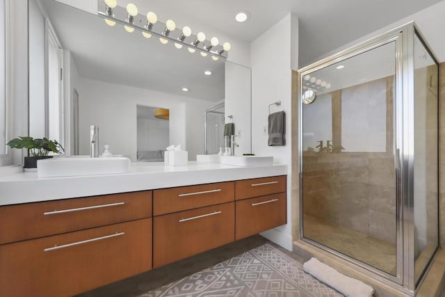 bathroom featuring vanity and a shower with door