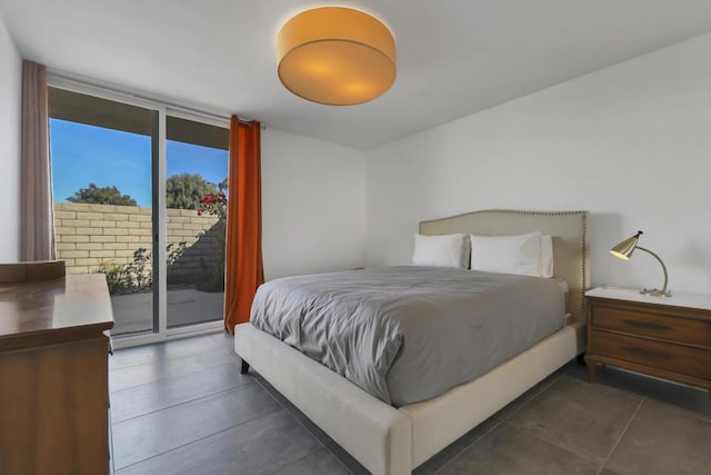 bedroom featuring expansive windows and access to exterior