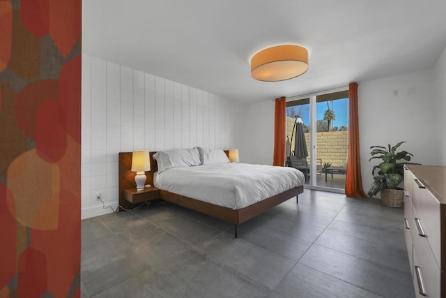 bedroom featuring floor to ceiling windows and access to exterior