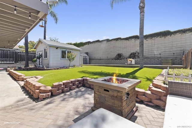 view of patio featuring an outbuilding and an outdoor fire pit