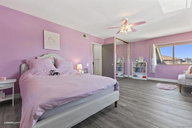 bedroom with ceiling fan and dark hardwood / wood-style flooring