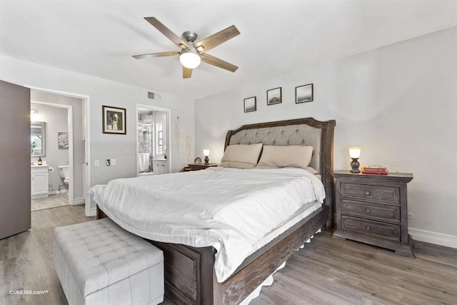 bedroom featuring ensuite bathroom, ceiling fan, and light wood-type flooring