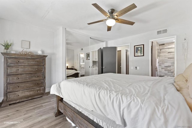 bedroom with ceiling fan, light hardwood / wood-style flooring, and ensuite bath