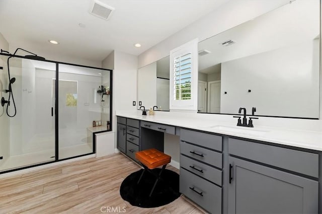 bathroom with an enclosed shower and vanity