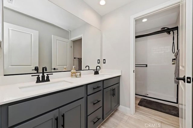 bathroom featuring walk in shower and vanity