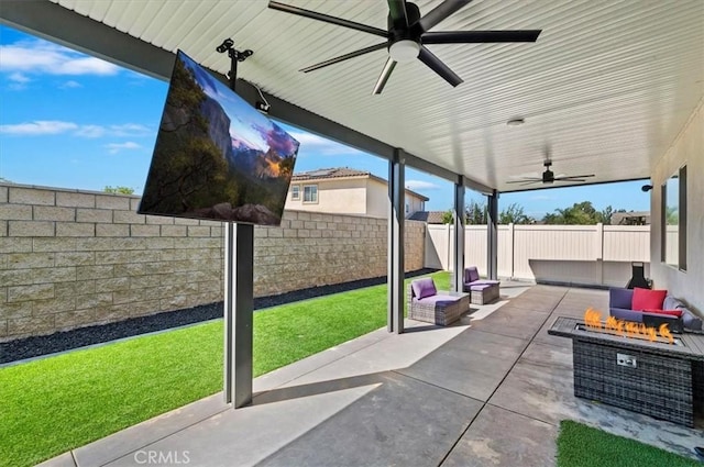 view of patio / terrace featuring ceiling fan and a fire pit