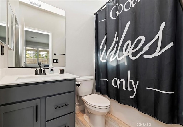 full bathroom featuring toilet, vanity, shower / bath combo, and hardwood / wood-style floors