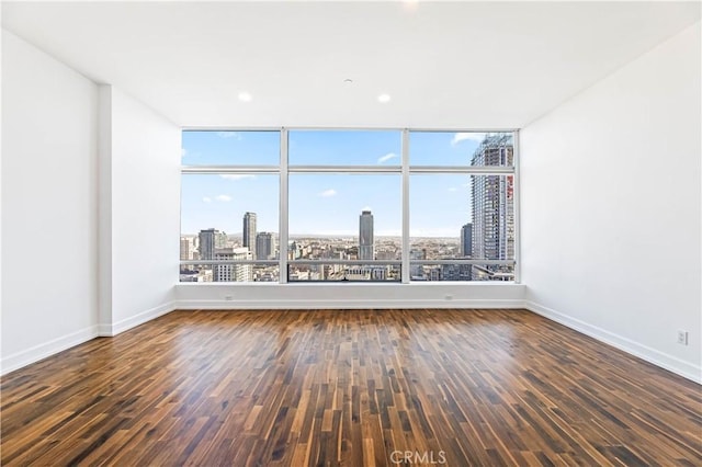 unfurnished room with dark hardwood / wood-style floors