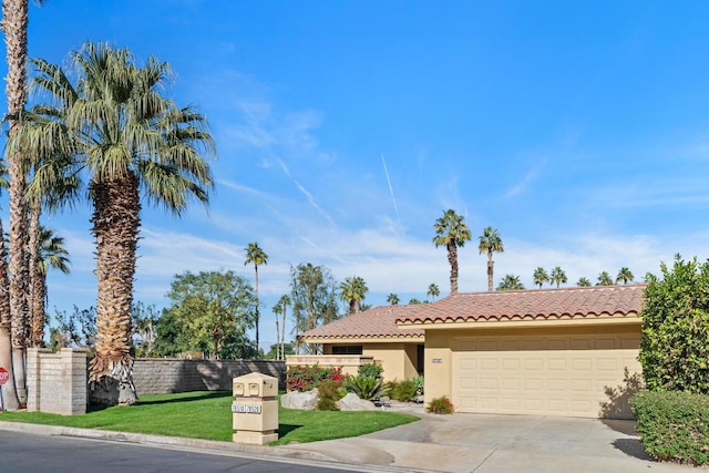 view of front of home featuring a garage and a front lawn