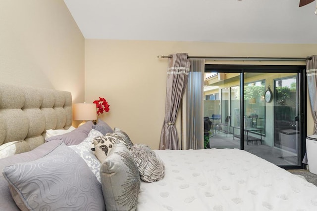 bedroom with access to outside and vaulted ceiling