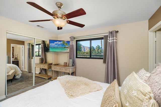 bedroom with ceiling fan, multiple windows, a closet, and carpet flooring