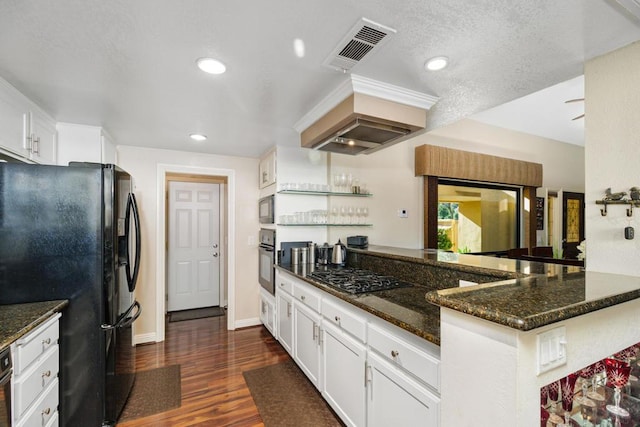 kitchen with black appliances, kitchen peninsula, dark wood-type flooring, and white cabinetry