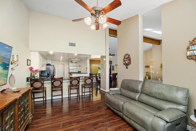 living room featuring ceiling fan, dark hardwood / wood-style flooring, beam ceiling, and high vaulted ceiling