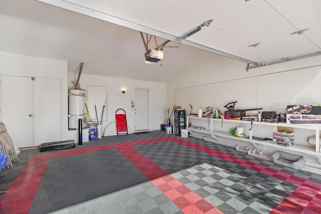 garage featuring a garage door opener and strapped water heater