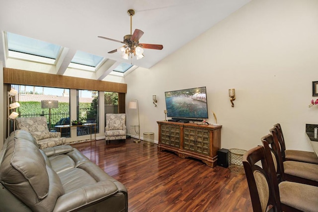 living room featuring ceiling fan, vaulted ceiling with skylight, and hardwood / wood-style flooring