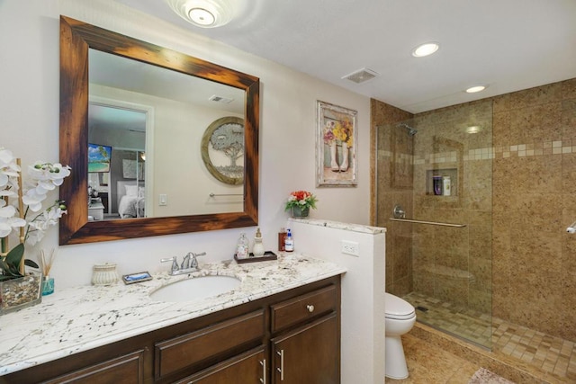 bathroom with tile patterned floors, an enclosed shower, vanity, and toilet