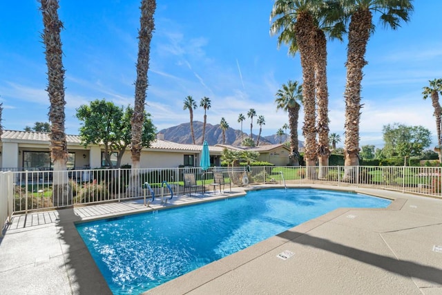 view of pool featuring a mountain view and a patio area